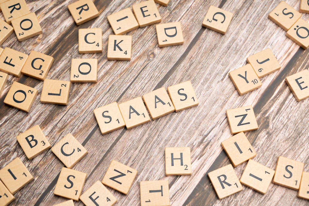 digital-01 Wooden letter tiles spelling SaaS on rustic wood. Ideal for cloud computing and business concepts.